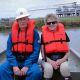 A man and a woman sitting in a small boat.